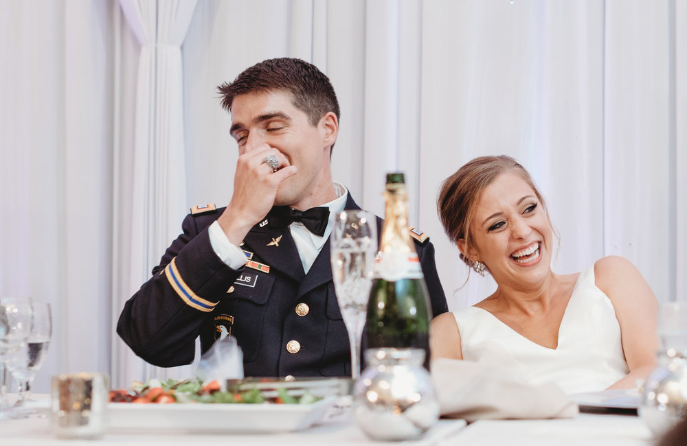 Bride-and-groom-laughing-during-speeches.jpg