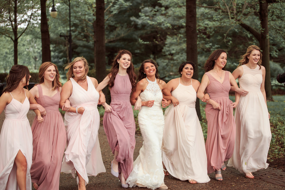 Fun bridesmaids skipping laughing wedding photo