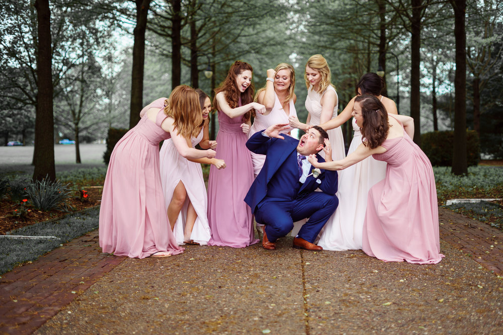 Groom getting beat up by bridesmaids