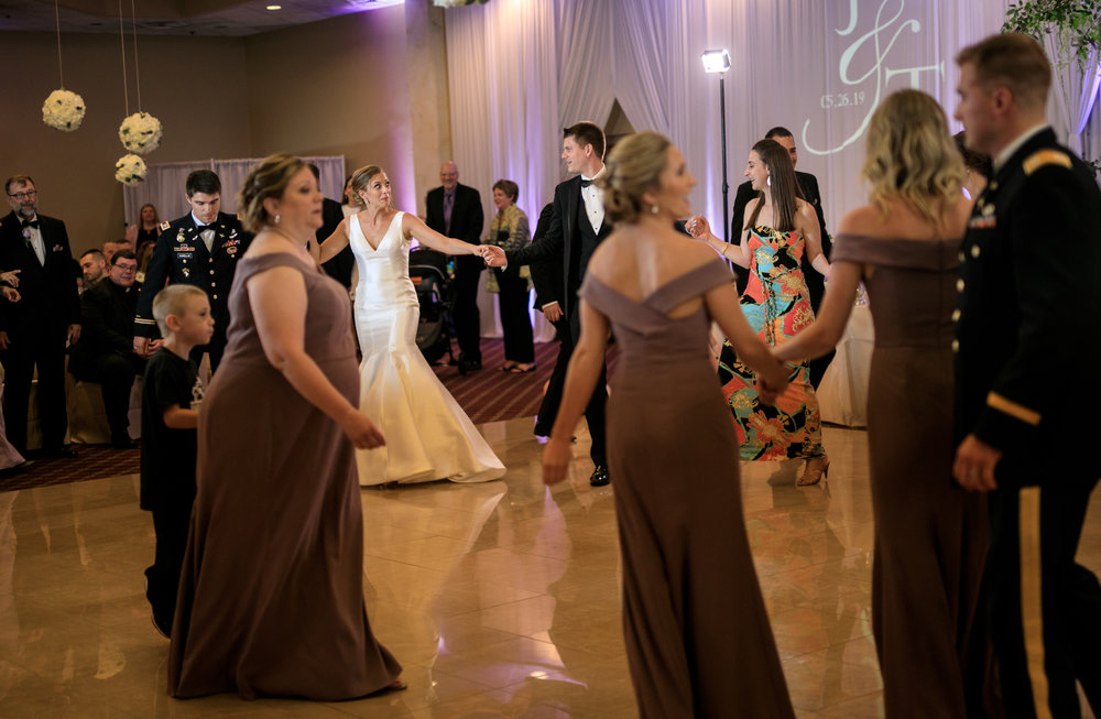 bride and groom greek dancing at weddig