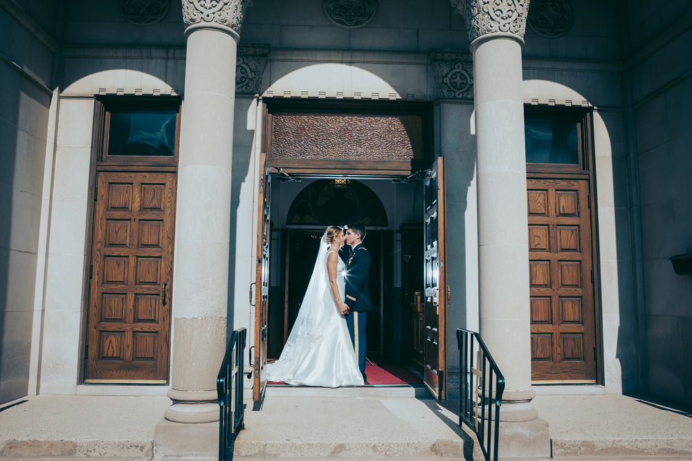 bride-and-groom-in-front-of-church-doors.jpg