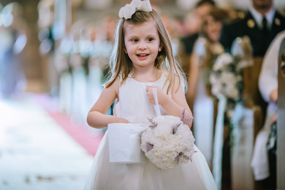 cute flower girl coming down the aisle