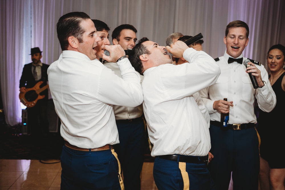groomsmens singing to bride