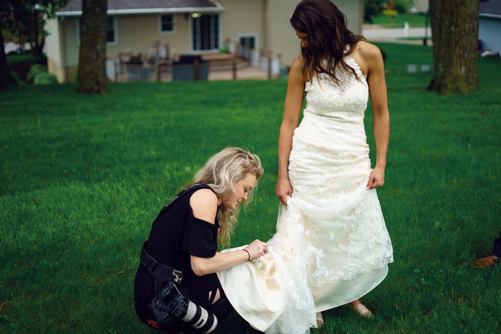 lauren ashley wedding photography photographer cleaning mud off dress