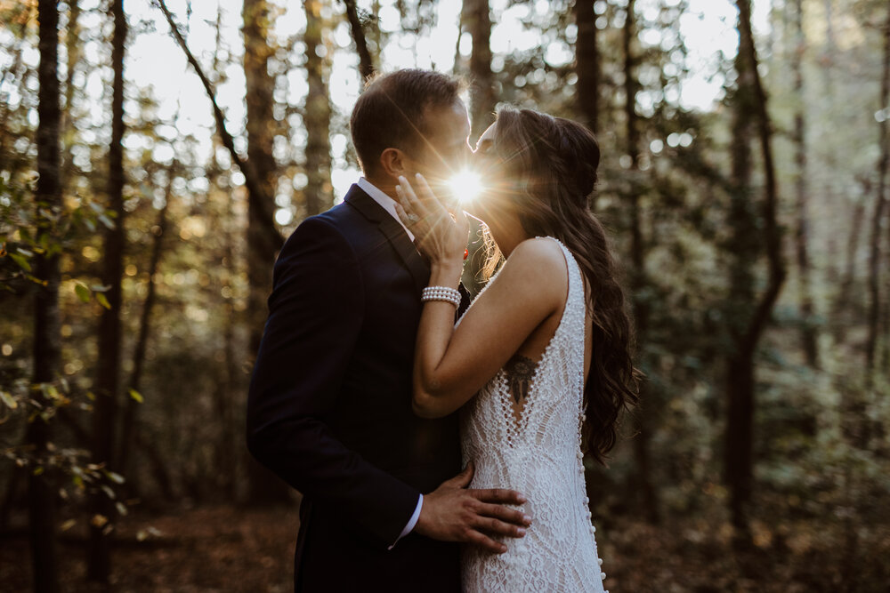 bride and groom kiss on their wedding day at sunset creative photography