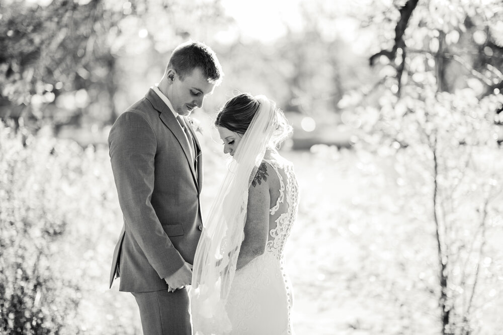 bride and groom share an intimate moment in this wedding photograph