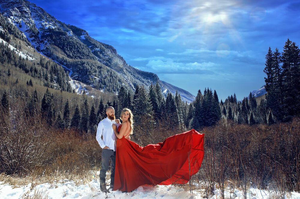 denver colorado engagement photography with a girl wearing a flowing red dress in the rocky mountain