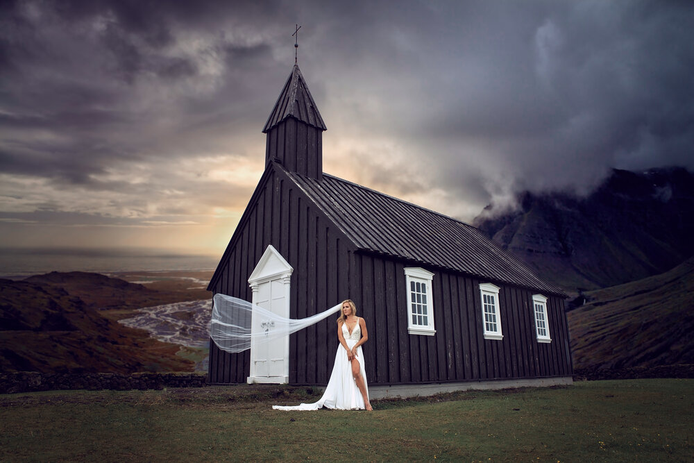 destination wedding photography of bride in dress at iceland little black church