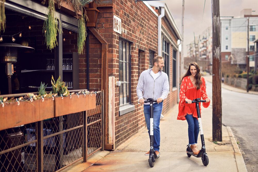 engagement photography by lauren ashley studios riding scooters in atlanta city streets