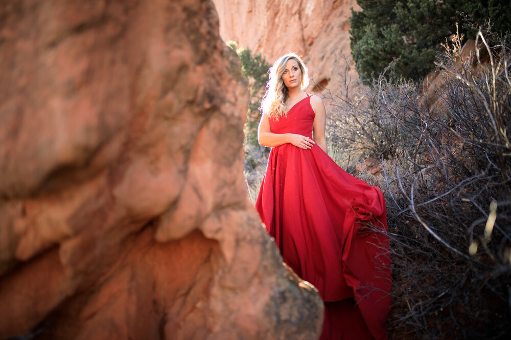 engagement photoshoot at garden of the gods in colorado springs wearing a flowing red dress