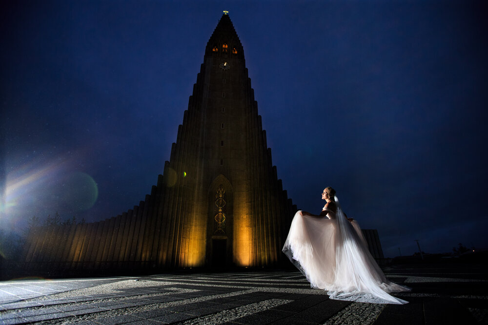 iceland destination wedding photographer takes this picture of a bride in front of hallgriCC msk