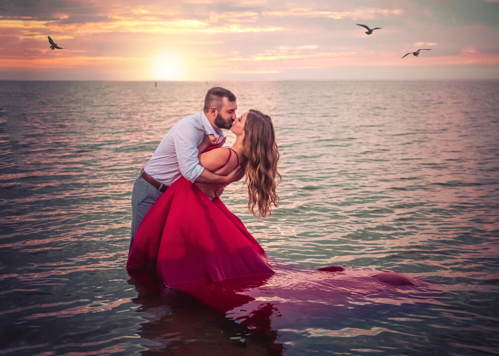 indiana dunes sunset engagement red dress in lake michigan photoshoot