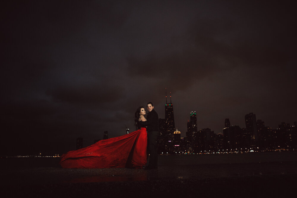 john hancock building behind a couple taking engagement photos with lauren ashley chicago best photo