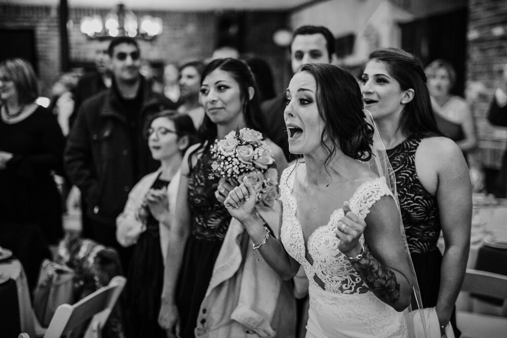 photography of a bride reacting to a sloth brought out as a surprise at her wedding like kristen bel