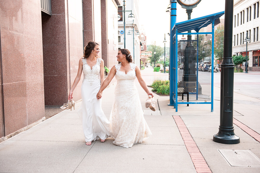 quad cities wedding photographer takes picture of bride and her maid of honor in moline