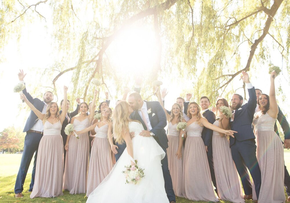 the bridal party celebrates the marriage of the bride and groom in this stunning sunlight wedding ph