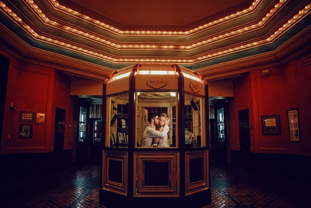 wedded couple take photos in movie theater will call with lauren ashley studios